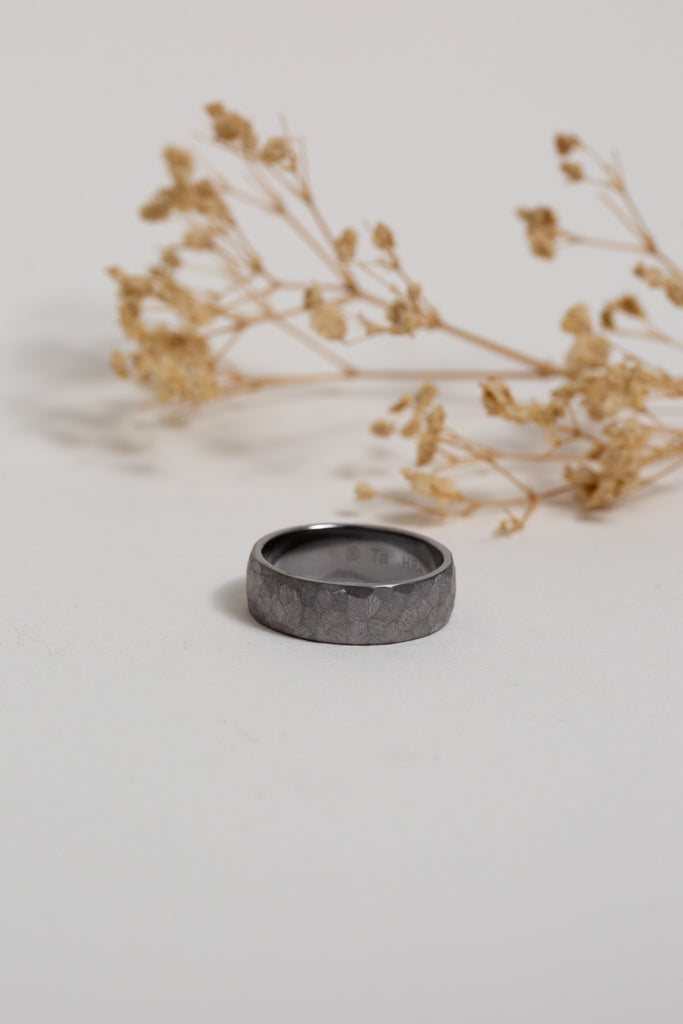 Gents black wedding band made from Tantalum (Ta).  The ring has a textured filed finish.