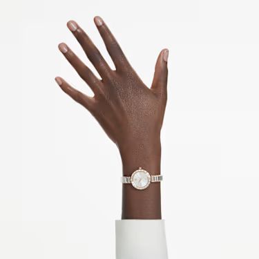 Model wearing a white top with the Swarovski Matrix bangle watch