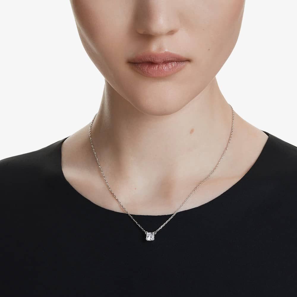 Model wearing a black top with a silver Swarovski Stella pendant