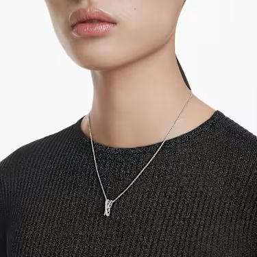 Model wearing a black top with a silver Swarovski Hyperbola pendant