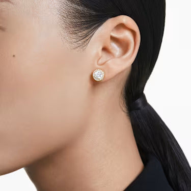 A model is wearing the Swarovski Una stud earrings