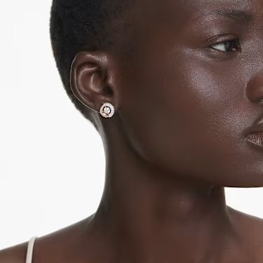 A model wearing the Swarovski Dextera Stud Earrings in Rose Gold