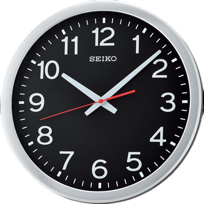 Seiko wall clock with a black dial and white numbers.